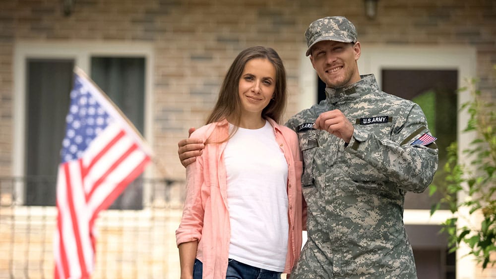 Soldier and wife showing keys to their new home.