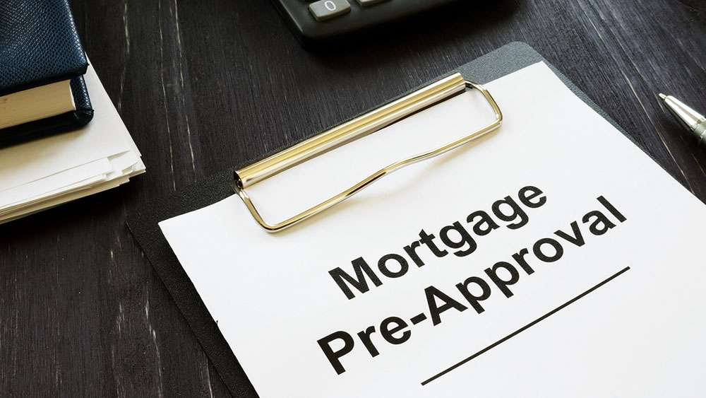Mortgage Pre-Approval papers on a clipboard sitting on a desk.