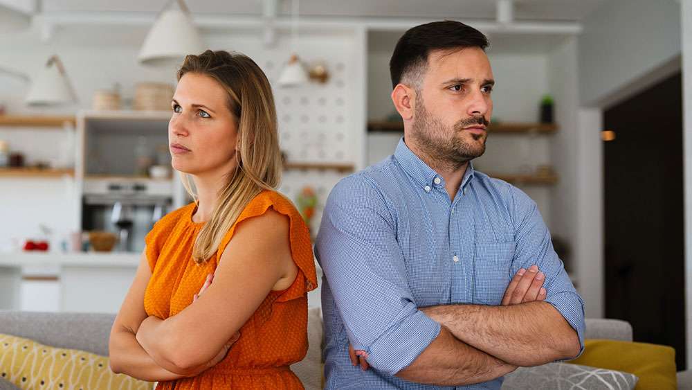 Couple conflicted over home ownership during a divorce.